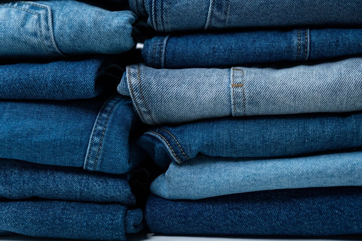 Stack of denim pants on shelves