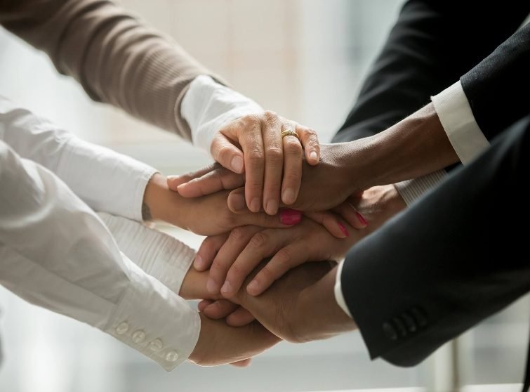 Team members joining hands